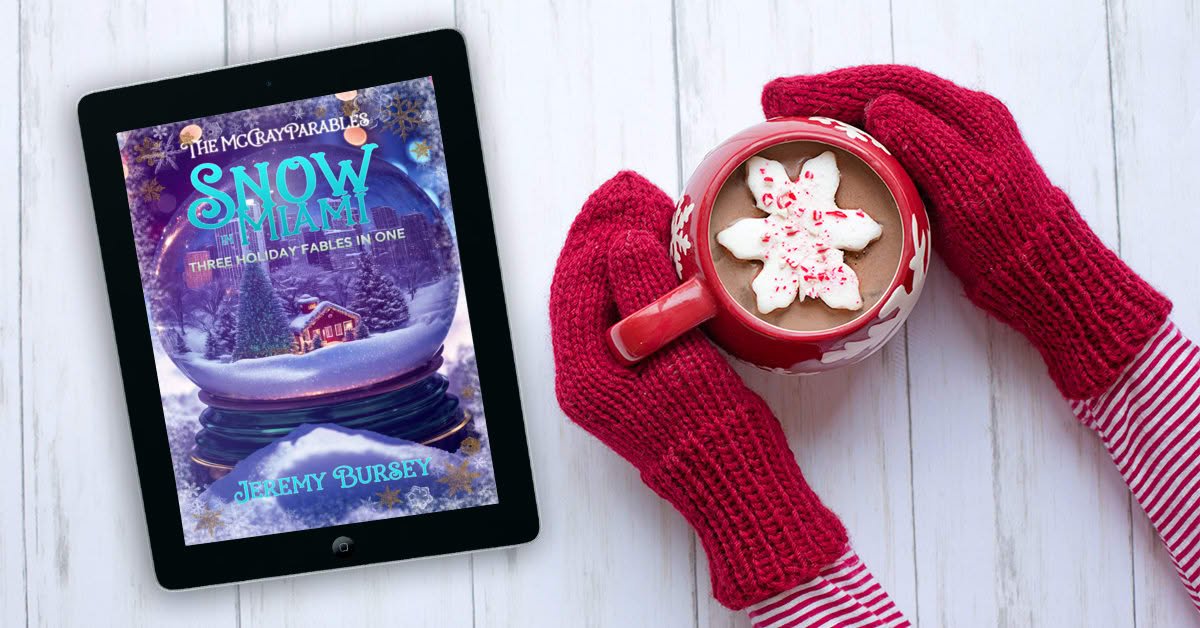 A person wearing red gloves holds a mug of hot chocolate with a snowflake-shaped marshmallow next to a tablet displaying the book cover 